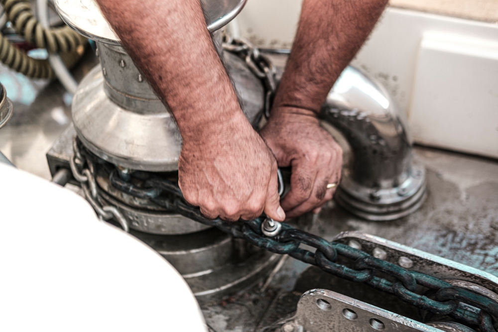 Marine mechanic servicing an outboard motor at the Outlaw Marine and 4x4 workshop in Darwin