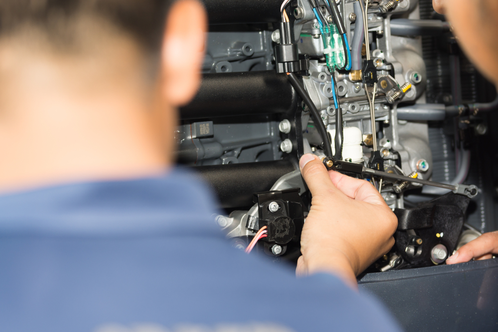 Marine mechanic working on a boat at Outlaw Marine and 4x4 Darwin